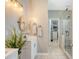 Bathroom with a glass-enclosed shower, double vanity, large mirror, and a view into the spacious walk-in closet at 422 Cabrill Dr, Charleston, SC 29414