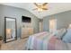 Well-lit bedroom with neutral walls, carpet flooring, a ceiling fan, and stylish furniture with a view into the bathroom at 422 Cabrill Dr, Charleston, SC 29414