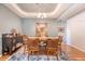Well-lit dining room with a chandelier, wood table set, and an area rug at 422 Cabrill Dr, Charleston, SC 29414