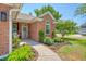 Inviting brick home with front yard flower beds and walkway to front porch at 422 Cabrill Dr, Charleston, SC 29414