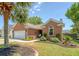 Charming brick home with a manicured lawn, a palm tree, and a cozy front porch display at 422 Cabrill Dr, Charleston, SC 29414
