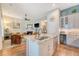 Open-concept living space with kitchen island, stainless appliances, and seamless flow to the cozy living room at 422 Cabrill Dr, Charleston, SC 29414