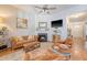 Cozy living room with a fireplace, leather seating, and a ceiling fan at 422 Cabrill Dr, Charleston, SC 29414