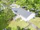 Aerial view of a backyard with deck, lawn, and mature trees create a private oasis at 5 Drummond Ct, Charleston, SC 29414