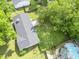 Aerial view shows backyard with a pool, mature trees, and deck for outdoor entertaining and enjoyment at 5 Drummond Ct, Charleston, SC 29414