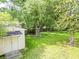 Backyard with lawn, lush trees, wooden shed, and wood fence in the distance create a serene and private outdoor space at 5 Drummond Ct, Charleston, SC 29414