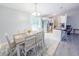 This dining room features a large table with seating and a door that leads to the porch at 5 Drummond Ct, Charleston, SC 29414