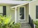 Close up of the home's front porch showing the front door and landscaping at 5 Drummond Ct, Charleston, SC 29414
