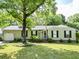 Inviting single-story home boasts a lush green lawn and mature trees providing shade at 5 Drummond Ct, Charleston, SC 29414