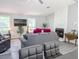 Bright living room with a decorative fireplace, comfortable furniture, and a large ceiling fan at 5 Drummond Ct, Charleston, SC 29414