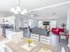 Bright, open-concept living room with stainless appliances and gray flooring at 5 Drummond Ct, Charleston, SC 29414