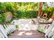 A private backyard with a seating area and brick fireplace surrounded by lush greenery and wood fencing at 50 South St, Charleston, SC 29403