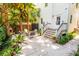 Charming backyard patio with brick fireplace and seating area surrounded by lush greenery and mature trees at 50 South St, Charleston, SC 29403