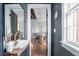 Modern bathroom with stylish fixtures, a sleek sink, and a view into the dining room at 50 South St, Charleston, SC 29403