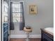 Cozy bedroom featuring a window with sheer curtains and a decorative side table at 50 South St, Charleston, SC 29403