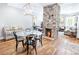Open dining room featuring a stylish table, brick fireplace, and hardwood floors, seamlessly connecting to the living area at 50 South St, Charleston, SC 29403