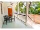 Inviting front porch with outdoor seating, featuring a charming wood door and painted ceiling at 50 South St, Charleston, SC 29403