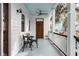 Charming front porch with outdoor seating and a view of the surrounding neighborhood at 50 South St, Charleston, SC 29403