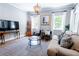 Inviting living room with hardwood floors, a stylish couch, and a chandelier, ideal for relaxing and entertaining at 50 South St, Charleston, SC 29403