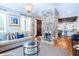 Bright living space with a central brick fireplace, hardwood floors, and comfortable seating, connecting to a modern kitchen at 50 South St, Charleston, SC 29403