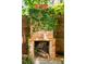 Rustic brick outdoor fireplace partially covered with climbing ivy, perfect for outdoor gatherings at 50 South St, Charleston, SC 29403
