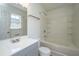 Bright bathroom featuring large vanity, toilet, bathtub with shower and small window at 5042 Thornton Dr, Summerville, SC 29485