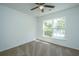 Bedroom featuring plush carpeting, ceiling fan, and window letting in natural light and neighborhood view at 5042 Thornton Dr, Summerville, SC 29485