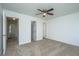 A spacious bedroom with neutral carpet, a ceiling fan, walk-in closet, and an ensuite bathroom at 5042 Thornton Dr, Summerville, SC 29485