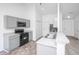 Well-lit kitchen featuring new appliances, light gray cabinets, and a breakfast bar overlooking dining area at 5042 Thornton Dr, Summerville, SC 29485