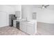 Open kitchen featuring grey cabinets and modern appliances overlooking the carpeted living area at 5042 Thornton Dr, Summerville, SC 29485