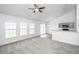 Open-concept living space with modern finishes, including a view of the kitchen and large windows at 5042 Thornton Dr, Summerville, SC 29485