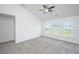 An open living room with 3 large windows bringing in tons of natural light and neutral carpeting at 5042 Thornton Dr, Summerville, SC 29485