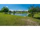 Scenic view of a pond surrounded by lush greenery and well-maintained landscaping at 5042 Thornton Dr, Summerville, SC 29485