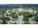 Aerial view of a community center with a baseball field, playground, and ample green space surrounded by trees at 5043 Victoria Ave, North Charleston, SC 29405