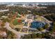 Expansive aerial view showcasing a vibrant community with a baseball field, playground, and various amenities at 5043 Victoria Ave, North Charleston, SC 29405