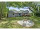 Expansive backyard featuring a patio, lush lawn, and mature trees, ideal for outdoor enjoyment at 5043 Victoria Ave, North Charleston, SC 29405