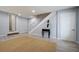 Finished basement features gray-toned wood floors and neutral walls, complemented by a staircase and stylish accents at 5043 Victoria Ave, North Charleston, SC 29405