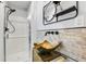 An elegant bathroom features a vessel sink, brick backsplash, and a modern shower at 5043 Victoria Ave, North Charleston, SC 29405