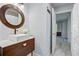 Modern bathroom with a round mirror, white vessel sink, and contemporary fixtures at 5043 Victoria Ave, North Charleston, SC 29405
