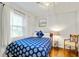 A stylish bedroom features hardwood floors, a comfortable bed, and charming coastal decor at 5043 Victoria Ave, North Charleston, SC 29405