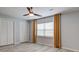 Cozy bedroom with a ceiling fan, gray wood flooring, and plenty of natural light at 5043 Victoria Ave, North Charleston, SC 29405