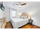 A bright bedroom showcases hardwood floors, a plush bed, and ample natural light at 5043 Victoria Ave, North Charleston, SC 29405