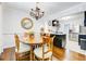 Dining area featuring hardwood floors, a chandelier, and an open layout connected to the kitchen at 5043 Victoria Ave, North Charleston, SC 29405