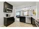 Modern kitchen with an island, stainless steel appliances, and views of the living and dining areas at 5043 Victoria Ave, North Charleston, SC 29405