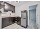 Compact kitchen featuring dark cabinetry, stainless steel appliances, and a granite countertop at 5043 Victoria Ave, North Charleston, SC 29405