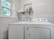Bright laundry room with white appliances, offering convenient space for laundry tasks at 5043 Victoria Ave, North Charleston, SC 29405
