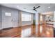 Bright open-concept living area with hardwood floors, neutral walls, and updated lighting fixtures at 5043 Victoria Ave, North Charleston, SC 29405