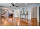 Spacious open-concept living area with hardwood floors, neutral walls, and modern light fixtures at 5043 Victoria Ave, North Charleston, SC 29405