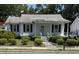 Charming bungalow with a well-manicured lawn and inviting front porch swing at 505 Blacks St, Walterboro, SC 29488