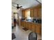 Functional kitchen with wooden cabinets, tile flooring, and window over sink at 505 Blacks St, Walterboro, SC 29488